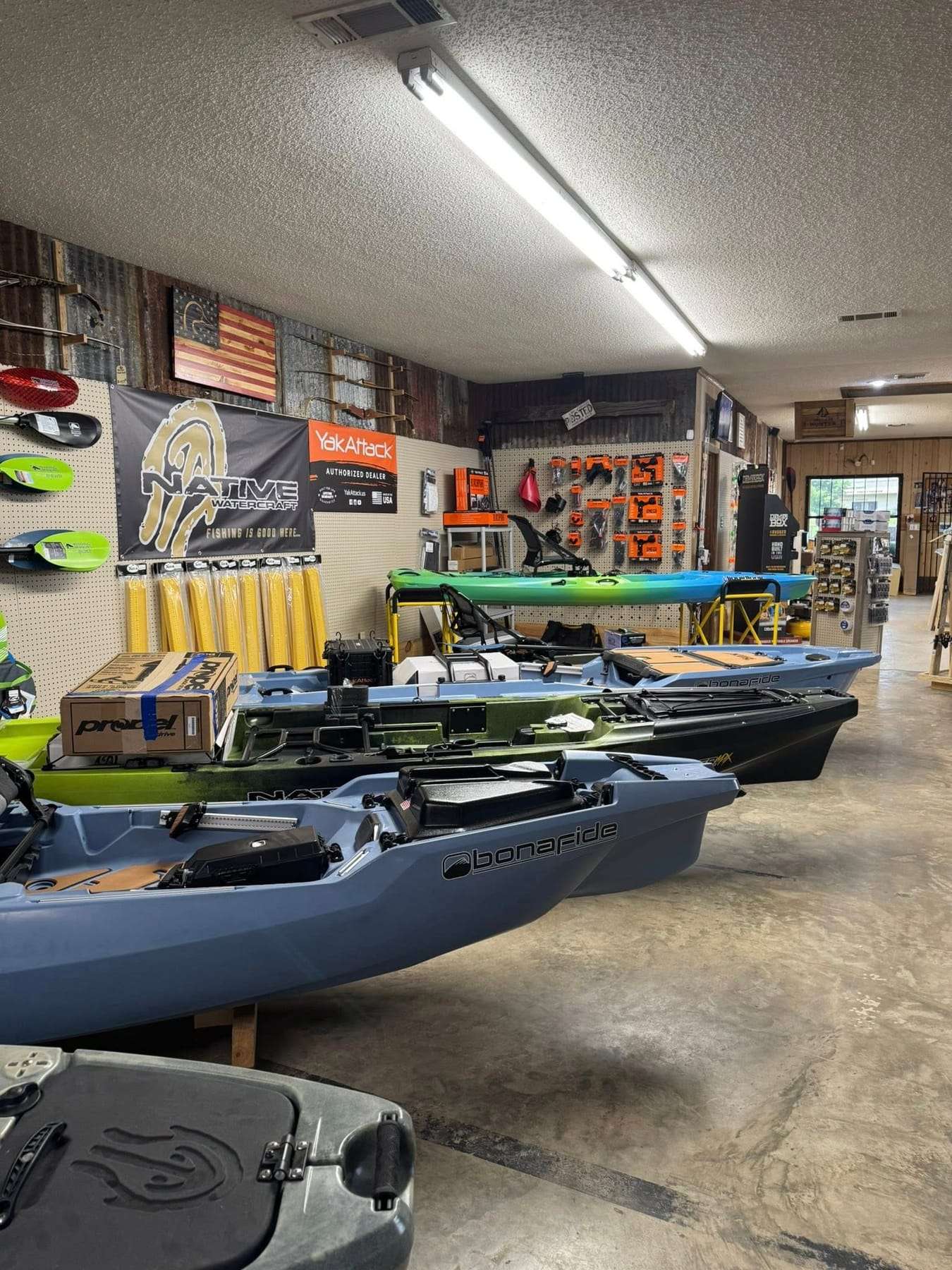 Fishing and recreational kayaks lined up in the showroom