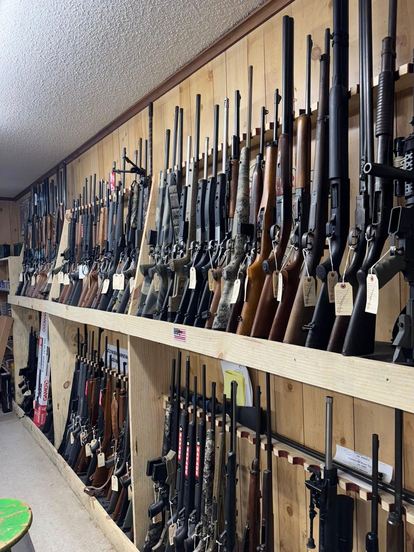 Long rack of rifles and shotguns inside the Covington gun shop
